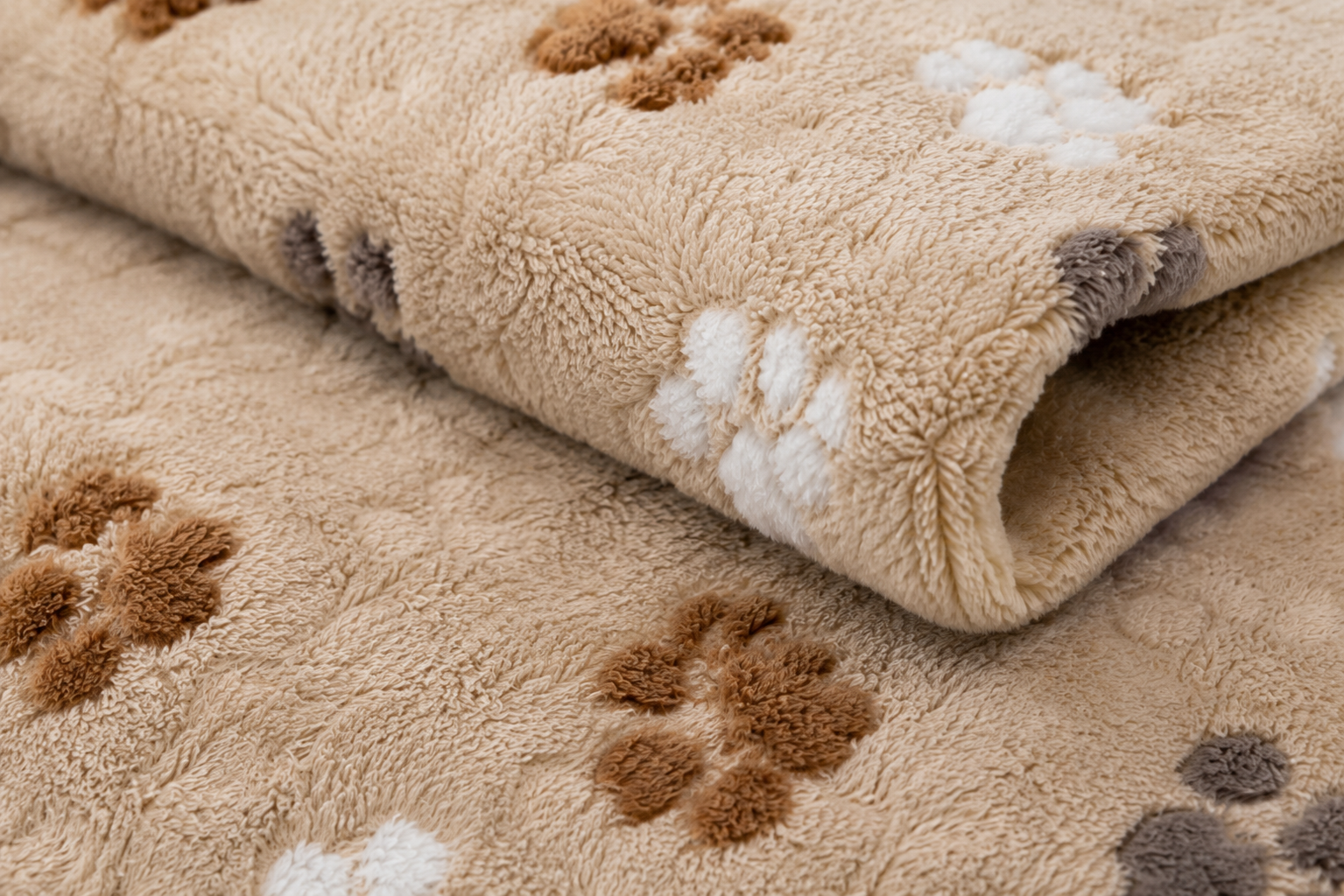 Close-up of a soft, plush beige rug with a playful paw print pattern in brown Soft Plush Pet Blanket with Paw Print Pattern for Dogs, Cats and Small Pets - Image 2