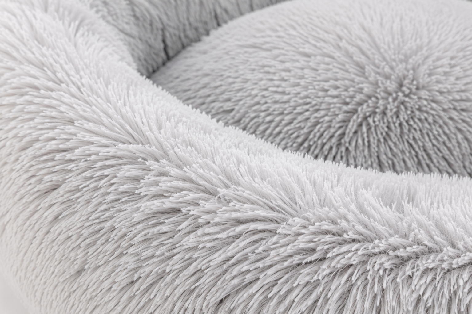Close-up view of a soft, fluffy, light gray fabric with intricate texture Round Plush Calming Pet Bed with Raised Rim for Dogs and Cats - Image 2